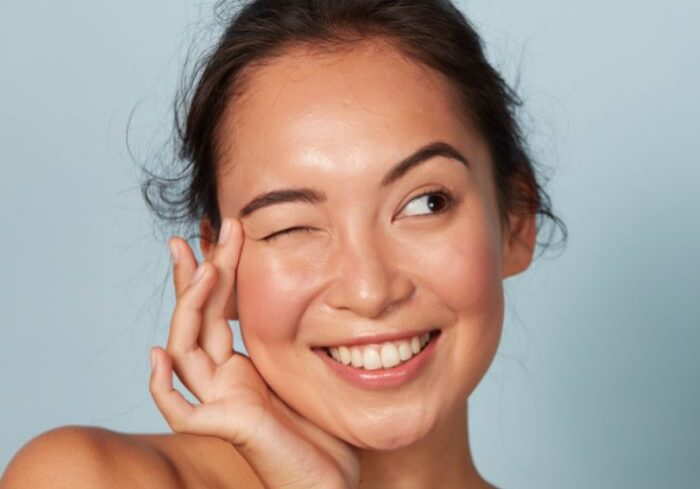 woman holding smooth face after injectables